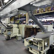 BUCKET TRANSFER. A bucket elevator (left) takes chocolate eggs to an overhead conveyor system much more gently than the cleated