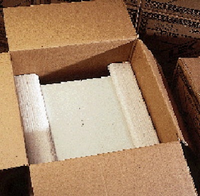 An operator packs L-shaped inserts into a case (above) prior to shipping. Besides improving its cushioning (opposite right and