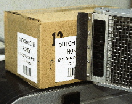 One applicator arm applies two separate labels to the end of each case (top, opposite page) and the side (left