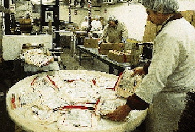 After each bag is coded, it passes through a metal detector and is discharged onto a turntable for manual case packing