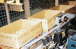 Cases are conveyed between the uncaser and the infeed carousel of the case balancing system (left). One of the two photoeyes sho