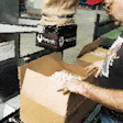 Loose-fill dispersion at Borders (above) is activated by a footpedal. A central conveyor moves cartons into position to be fille