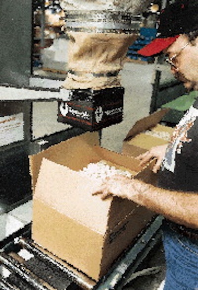 Loose-fill dispersion at Borders (above) is activated by a footpedal. A central conveyor moves cartons into position to be fille