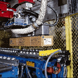 The robot?s gripper head picks up a case (above) after its bar-code label has been scanned. The scanned information is used to i