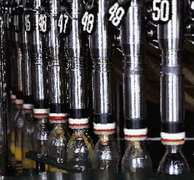 Bottles ease onto and off of the filler turret via oversized-diameter starwheels (left), which cut down on splashing associat