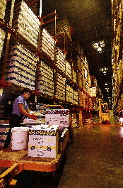 A Sysco warehouse worker stacks cases to complete a customer?s order before it?s shipped