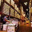 A Sysco warehouse worker stacks cases to complete a customer?s order before it?s shipped