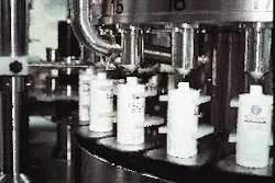 Near the end of the turret?s rotation, fill nozzles cut off based on the weight recorded from each bottle?s individual load cell