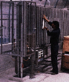 An operator loads ends into a vertical pocket on one of nine Rotofeeder machines located on a mezzanine level at La Coste?a (lef