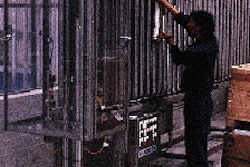 An operator loads ends into a vertical pocket on one of nine Rotofeeder machines located on a mezzanine level at La Coste?a (lef