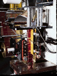 The paper filter unwind and bagging unit are shown close-up (left), while the overwrapping station appears above. Finished ov