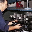 This close-up shows the starwheels and center guide for an air cleaner at Seagram?s LaSalle plant. Located on the center guide i
