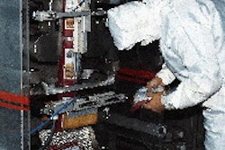 Sanitation measures in the HEPA-filtered packaging room include full garb, mask and boots for the operator, who also passes thro