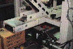 Mounted on the top-and-bottom taper is an ink-jet coder that prints name of product, expiration date, and lot code on one side