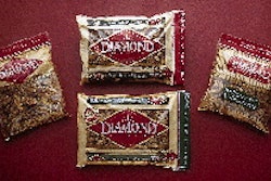 Two reciprocating fill funnels deliver walnuts to open bags, two at a time (above). Downstream, bags are picked up by robotic he