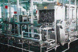 Once the 5-gal jugs have been sanitized, they are automatically conveyed around a corner and into the filling chamber (left). Wi