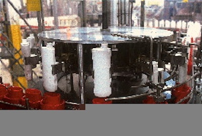 After containers are inserted into pucks by a rotary turret (top) that1s integrated into the unscrambler (at left, opposite page