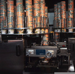 Cups are denested and sent into the packaging line by two rotary cup feeders, each of which holds 20 stacks of 50 nested cups.