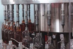 The 40-valve gravity/vacuum filler selected by Jim Beam minimizes product foaming to permit filling speeds of 180 bottles/min. T