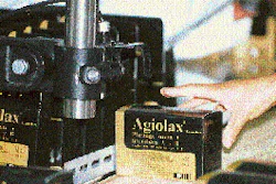 An operator applies an updated price code to a package by sending it past an ink-jet coder.