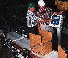 J.R. Simplot?s Martin Greenbank (below left) and distributor representative Bob Scott make an adjustment to the checkweigher con