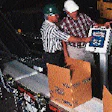 J.R. Simplot?s Martin Greenbank (below left) and distributor representative Bob Scott make an adjustment to the checkweigher con