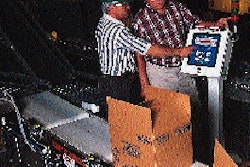 J.R. Simplot?s Martin Greenbank (below left) and distributor representative Bob Scott make an adjustment to the checkweigher con