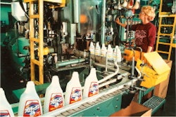 Machine operator Martha Johnson evaluates finished bottles slated for overseas distribution as they move along the line at the O