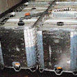 A galvanized steel cage permits Pepper Source personnel to see through to the inner HDPE liner to gauge product level