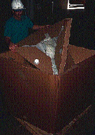 Once the sides of the container are raised, the operator inserts the bag cassette into the box (right). The fitting on the bag