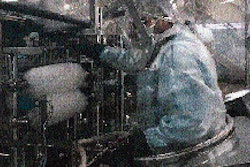 Here an operator has entered the intervention suit to make an adjustment in the area of the filler. The suit makes such adjustme