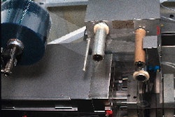 The vinyl base material unwinds to a pre-heating station to initiate the thermoform/fill/seal process. The pharmaceutical-grade