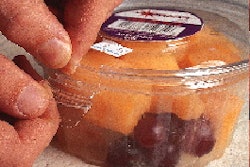 The PS resin used for Wilkinson?s DeltaPak, shown here in the trim press, has a modifier that gives the container just the right