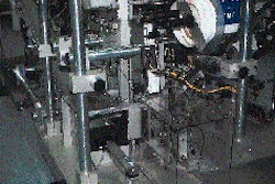 Within this chamber, two side-by-side cartons are labeled at each of their ends simultaneously to create a unit pack