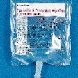 Filled bags of pre-mix antibiotics (such as the one at left) convey to a manual inspection station (above) where production asso