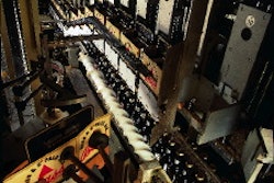 Pre-glued basket carriers with unsealed bottoms are placed in moving flights that guide the carriers over bottle groupings, afte