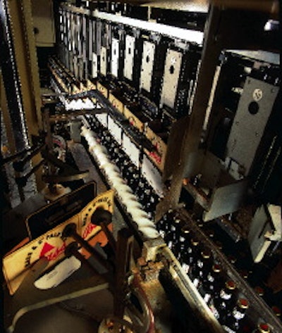 Pre-glued basket carriers with unsealed bottoms are placed in moving flights that guide the carriers over bottle groupings, afte