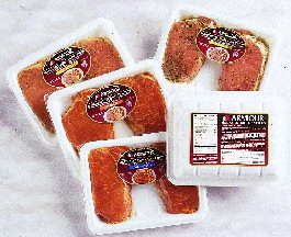 Shown are several of Swift?s Armour? marinated pork chop varieties. Chops are spaced about 1? apart within a multi-layer tray p