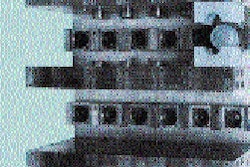 In the foreground are 12 freshly blown bottles waiting to be discharged by pickoff-pins. Visible in the background are 12 prefor
