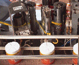 As labels unwind from the roll, they pass through a perforation wheel, followed by a series of tensioning rollers that compensat