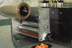 After filling, trays are evacuated, backflushed and lidded two-up on a rotary system. Then they1re loaded onto wheeled racks and