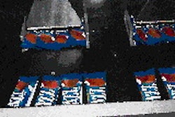 Bars discharge from the wrapper six at a time, with three continuing on one right-angled conveyor (above), three on another. Aft