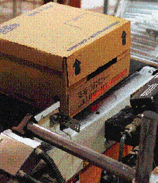 After a bar code is ink-jet printed onto cases of paint cans, it is scanned by a bar code decoder as a quality check. The scanne