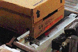 After a bar code is ink-jet printed onto cases of paint cans, it is scanned by a bar code decoder as a quality check. The scanne