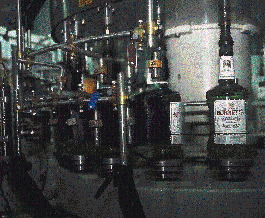 Brushes wipe neck and body labels onto spirits bottles on Heaven Hill?s PET filling line (above), and to 750-mL square glass bot