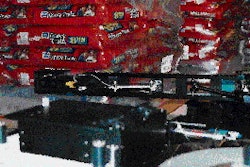 An articulating swing arm on Heinz?s print-and-apply labeler applies two labels, with identical information, first to one si