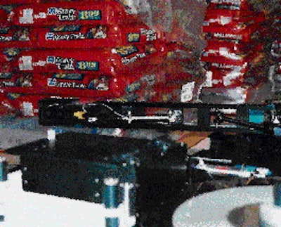 An articulating swing arm on Heinz?s print-and-apply labeler applies two labels, with identical information, first to one si