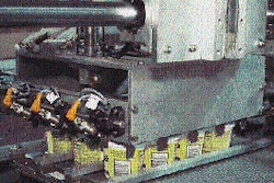 Reciprocating pickup head mechanically grips a case load of cups (left) and delivers them to a waiting case blank (above