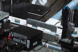 A scanner on the labeler verifies bar codes as labels unwind from rollstock. Two similar scanners are mounted on the cartoner an