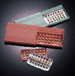 Prior to picking, blister packs travel through a long infeed section (above) and transfer to a white-ribbed flighted indexing be